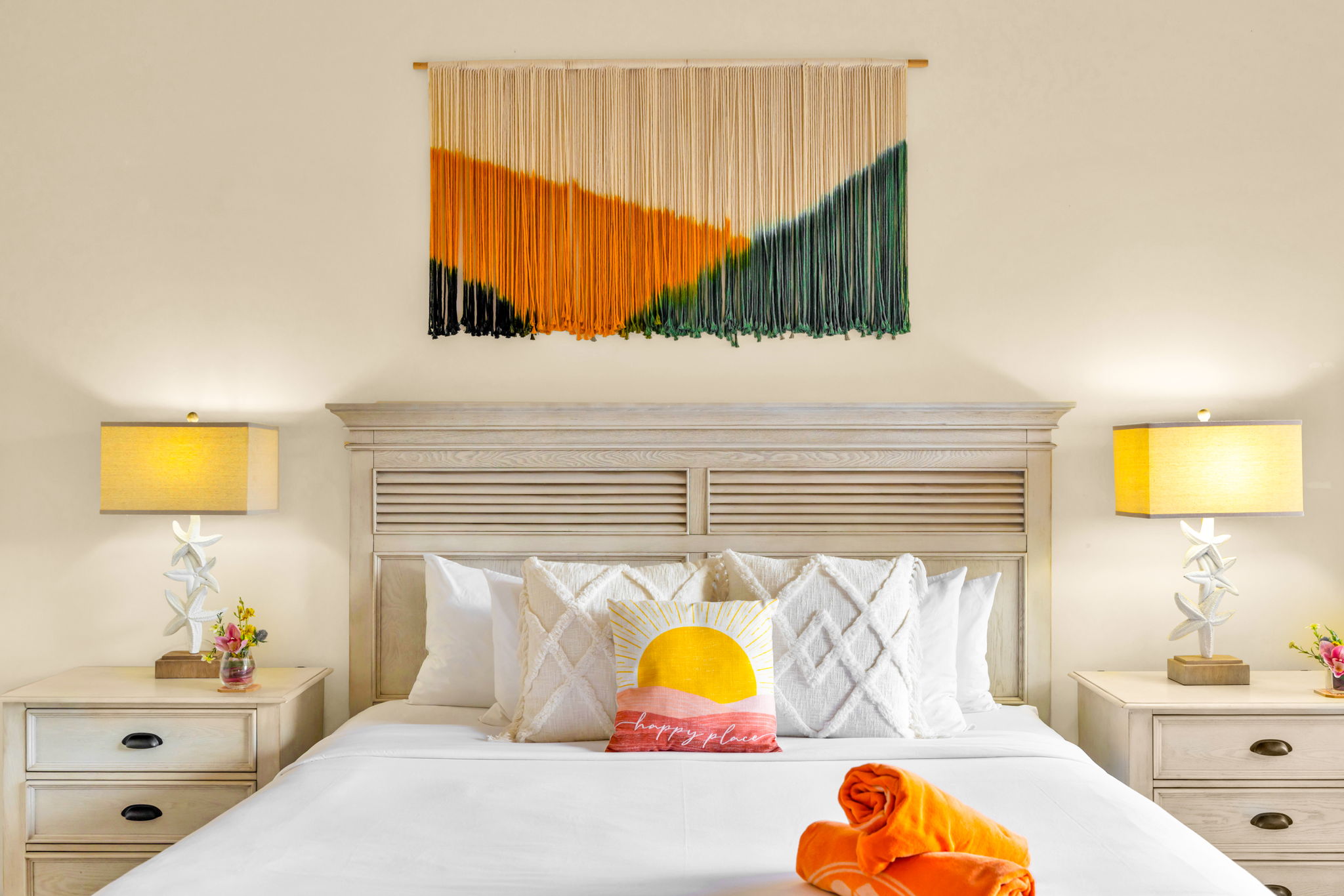 King bed with colorful accents and crisp linens for restful nights.