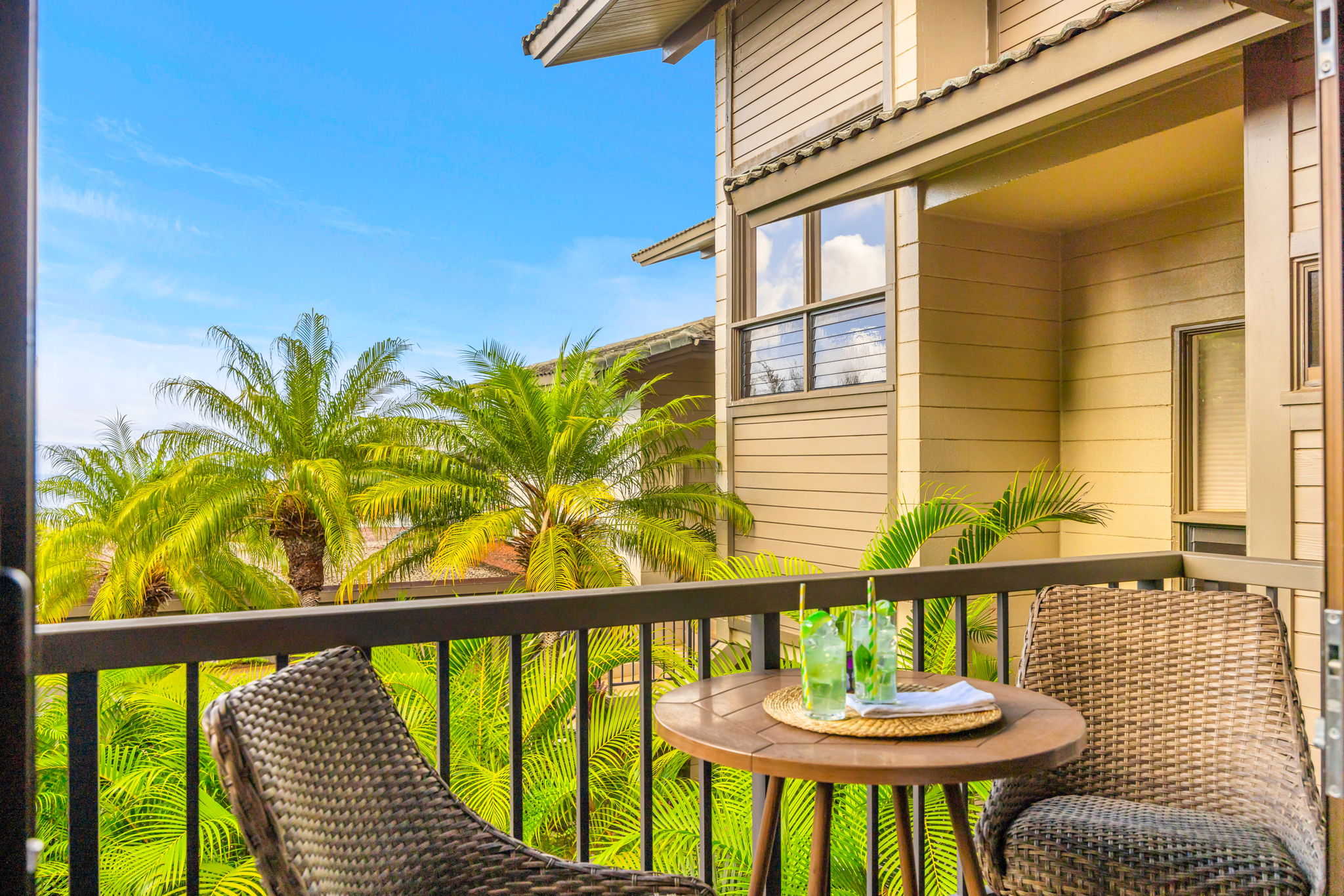 Lounge on your shaded lanai with lush tropical landscaping just beyond the railing.
