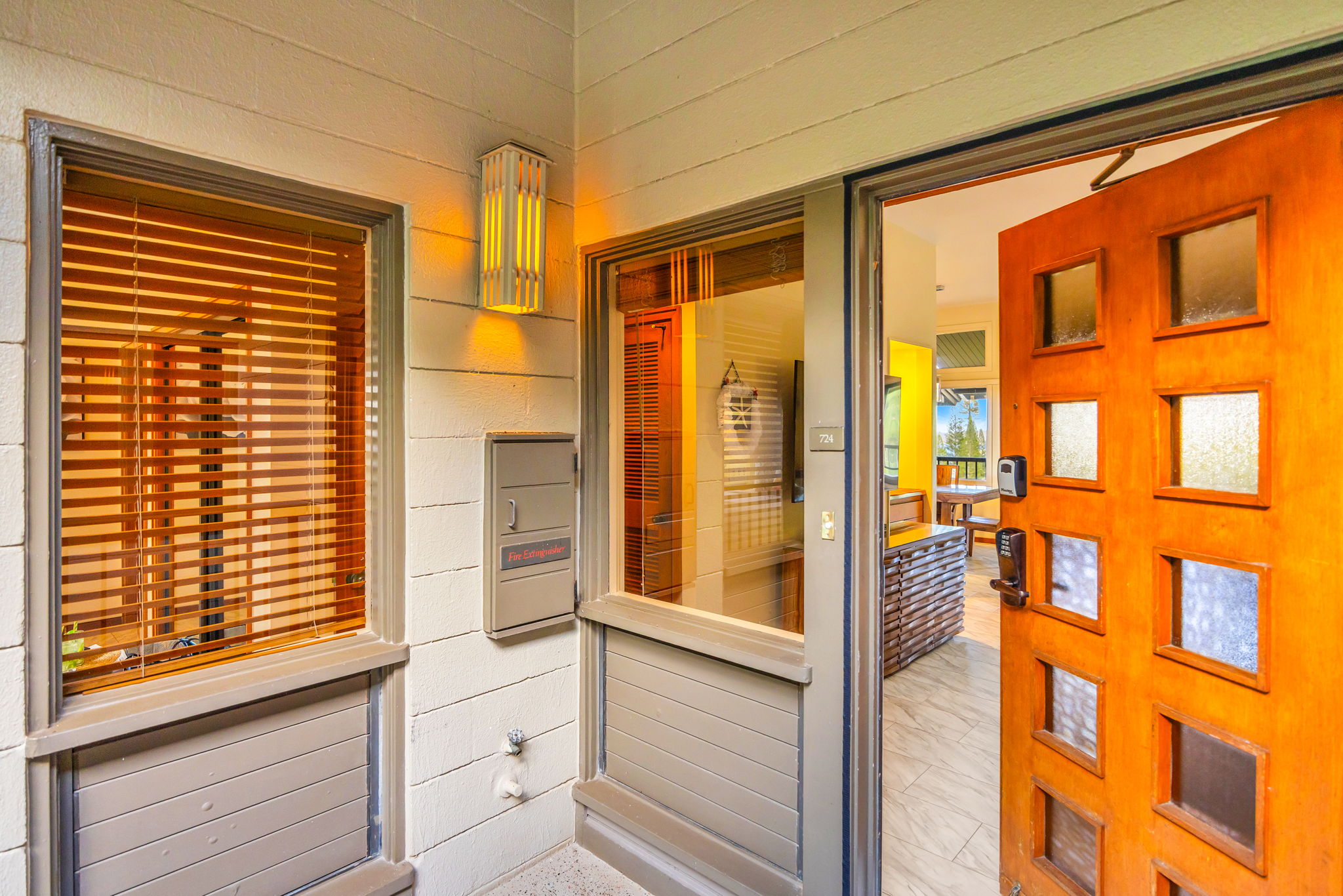 Charming wood entry adds a warm welcome with Hawaiian touches.