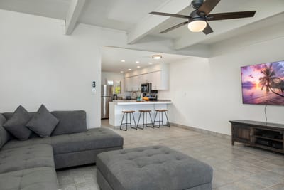 Natural wood tones, coastal textiles, and clean lines make this space feel effortlessly relaxed and family-ready