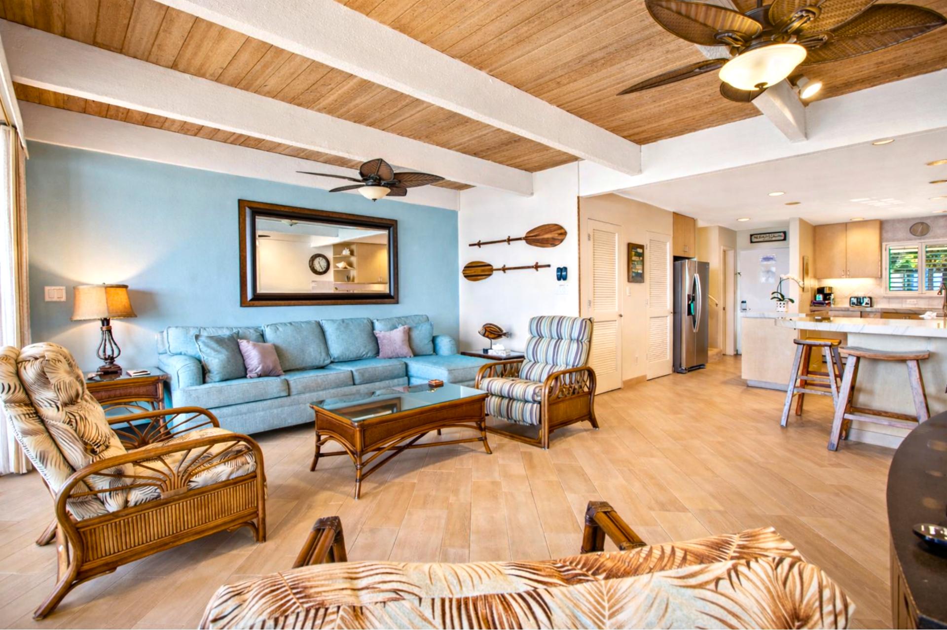 Natural wood ceilings and island inspired furnishings create an inviting living space that opens directly to your oceanfront lanai.