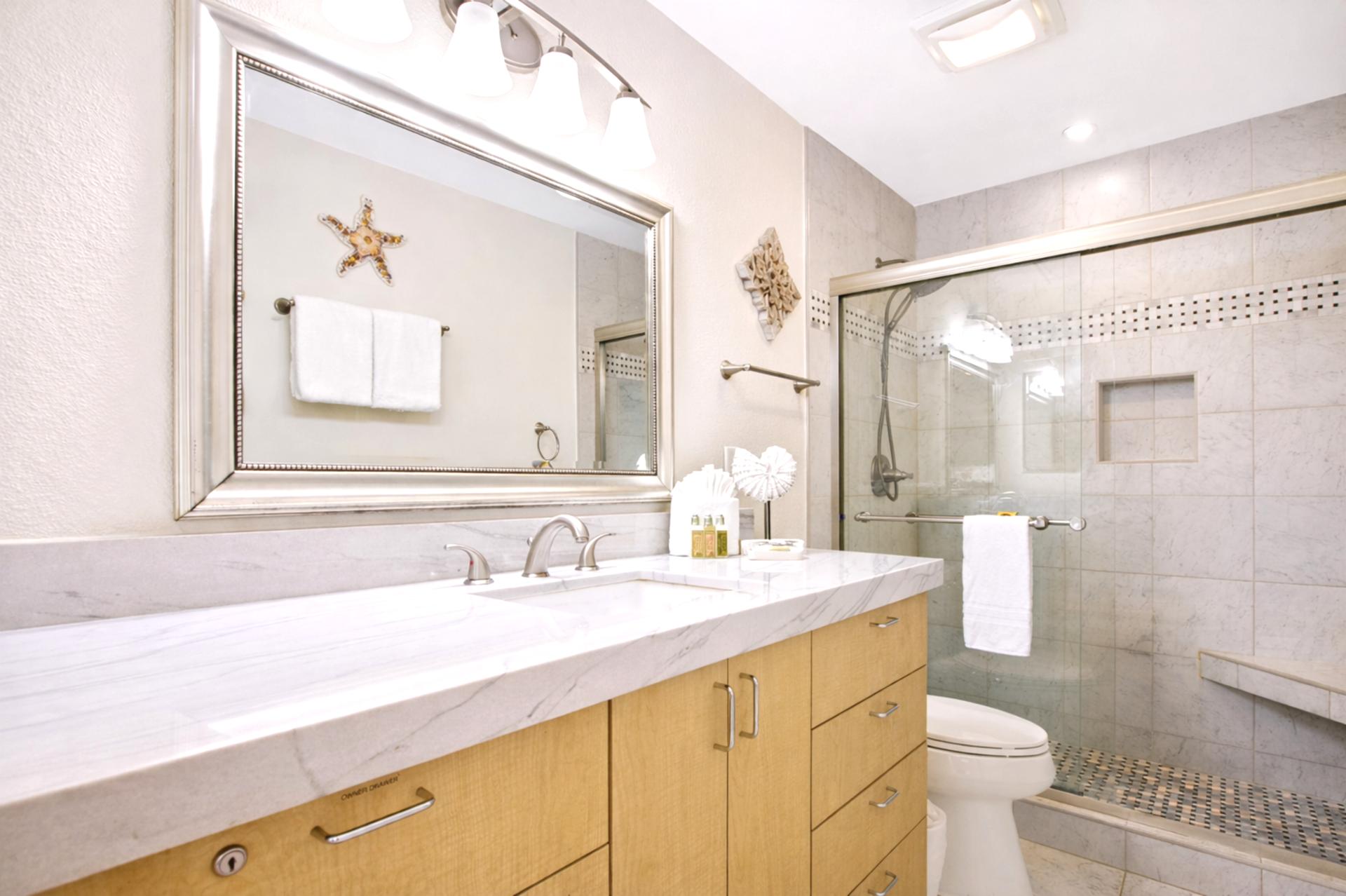 Your bathroom features a wide vanity with generous counter space and a large mirror for easy mornings before exploring.