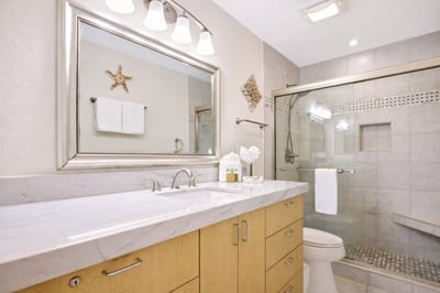 Your bathroom features a wide vanity with generous counter space and a large mirror for easy mornings before exploring.