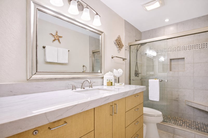 Your bathroom features a wide vanity with generous counter space and a large mirror for easy mornings before exploring.