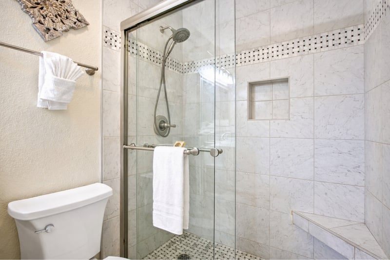 Step into your tiled walk in shower, complete with glass enclosure and built in niche for convenience and complimentary luxury L'Occitane bath amenities.