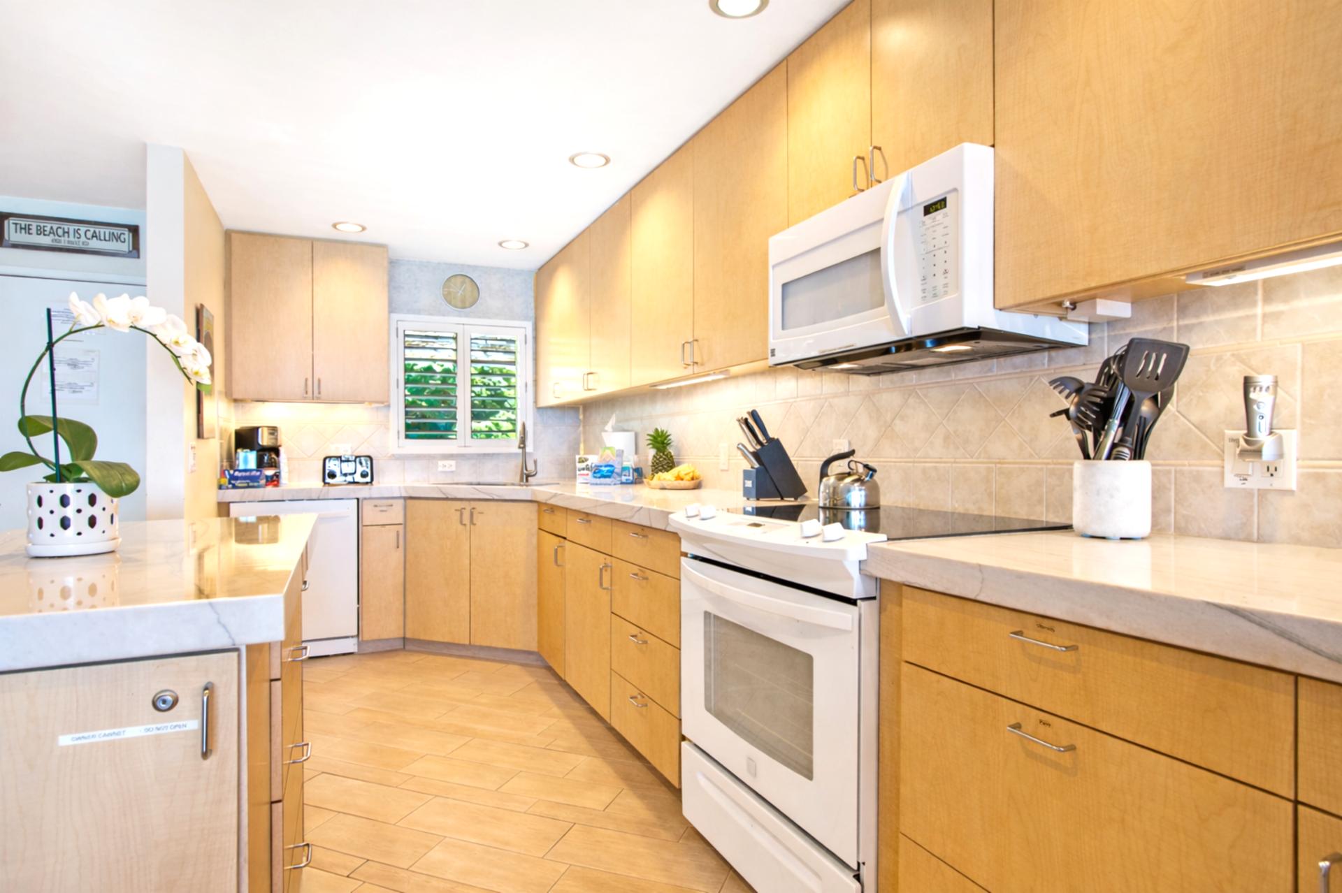 Your fully equipped kitchen features generous counter space and bar seating, making it easy to serve breakfast before the beach.