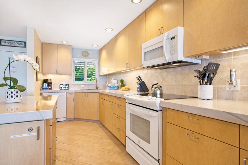 Your fully equipped kitchen features generous counter space and bar seating, making it easy to serve breakfast before the beach.