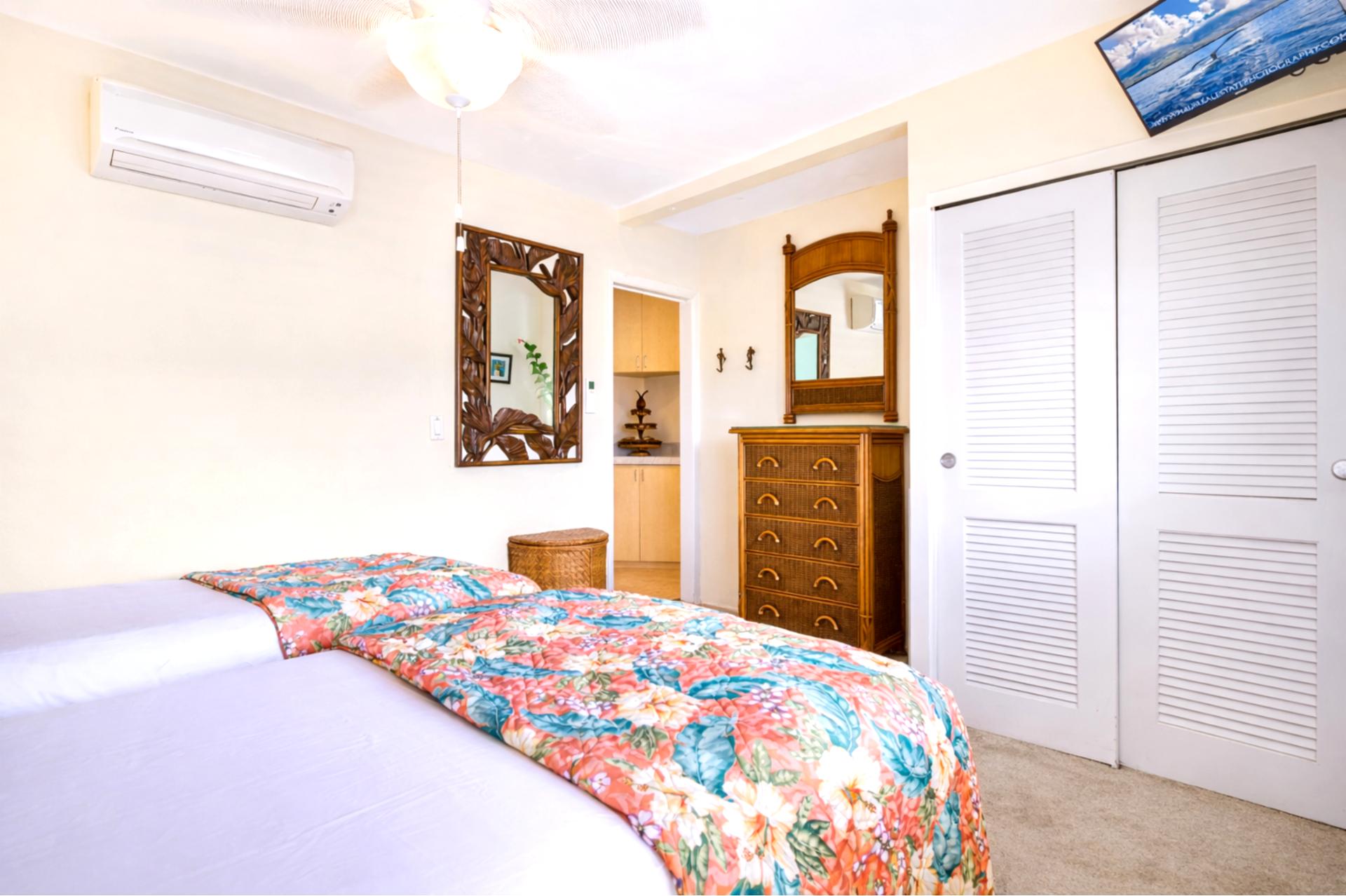 Colorful bedding and classic wood furnishings give your bedroom a relaxed island feel for a comfortable nights rest.
