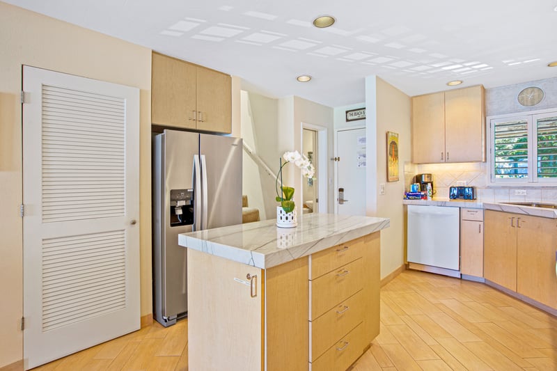 This golden-hued kitchen is a canvas of calm, where morning light, sea breeze, and simmering joy come to mingle