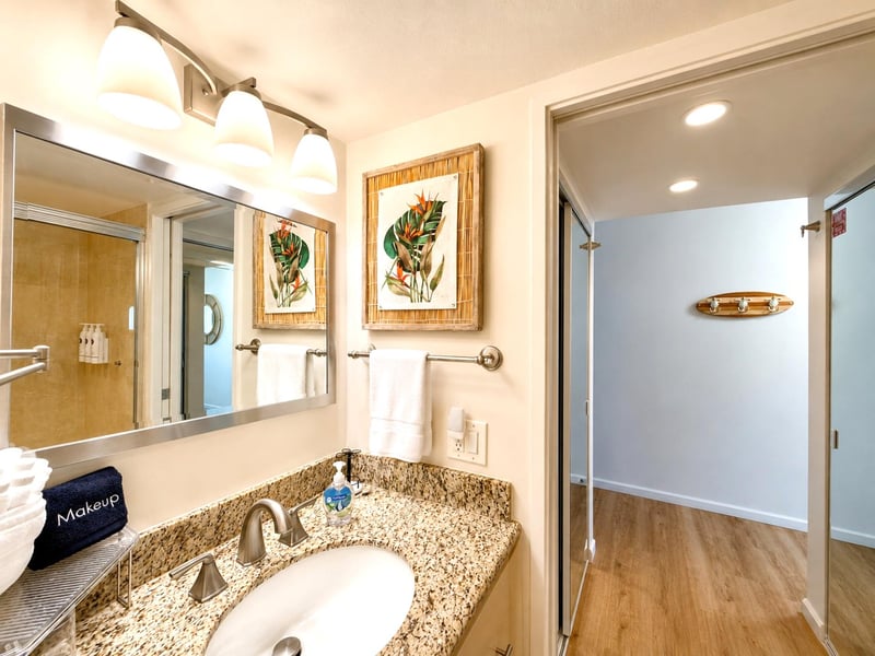 The spa inspired bathroom features a well lit vanity and ample counter space. Additionally, full length mirrors, making getting ready a breeze MAH-1002