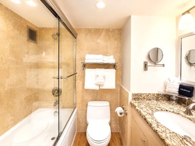 Refresh in the spacious bathroom with a beautifully tiled shower and tub combo