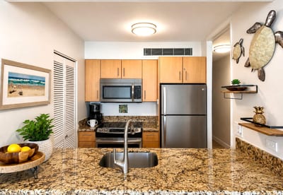 Prepare island inspired meals in the fully equipped kitchen with modern appliances and granite countertops