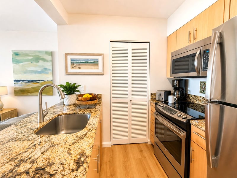 The well appointed kitchen features granite countertops stainless steel appliances and everything needed for your stay MAH-1002