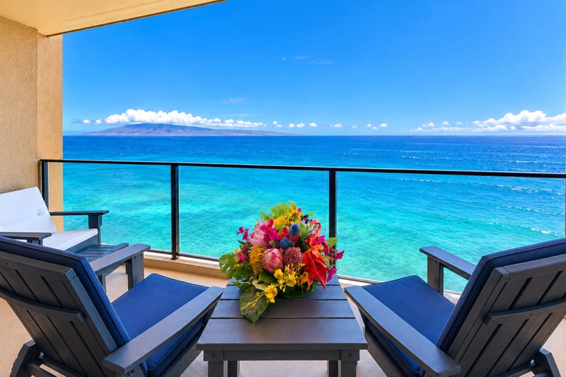 Lanai with two cushioned chairs facing the Pacific and island views on the horizon MAH-1002