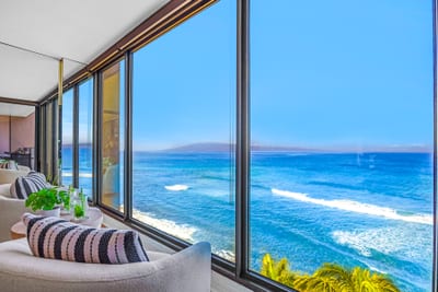 A cozy seating corner lets you sip your morning coffee and watch the waves, without ever leaving the living area.