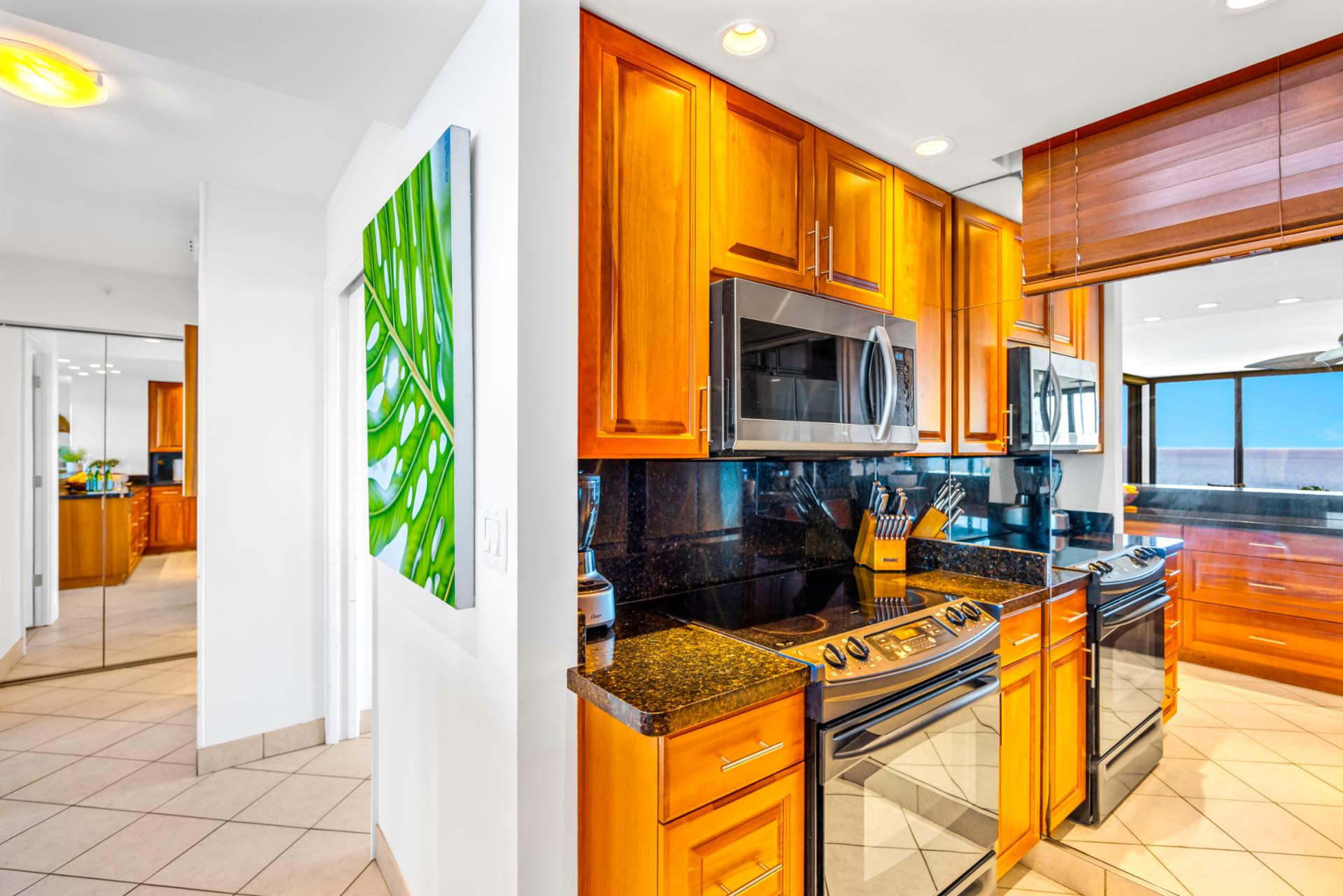 Clean lines and classic cabinetry make the kitchen feel polished, ready for quick bites before beach time.