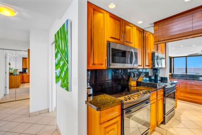 Clean lines and classic cabinetry make the kitchen feel polished, ready for quick bites before beach time.