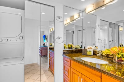 Enjoy a bright bathroom with a glass shower and plenty of counter space for getting ready after the beach.