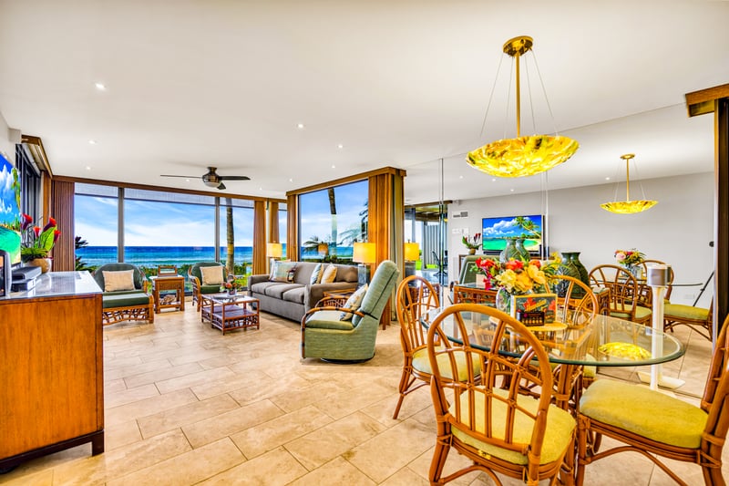 Easy mealtime setup with seating for four, ocean light, and open access to the kitchen.