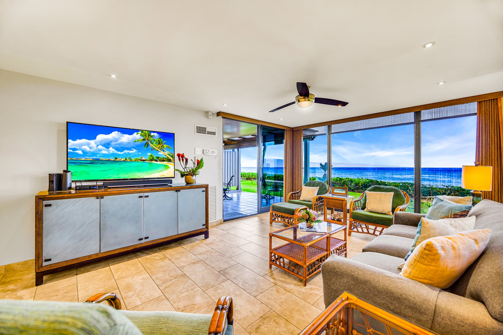 Ocean views greet you from the living room, complete with a 65" Smart TV and ceiling fan. MAH-109
