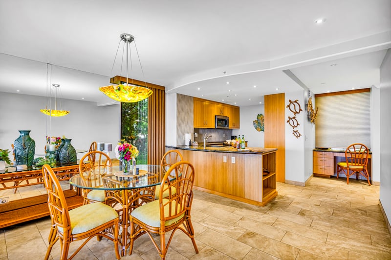 Gather at your dining table for four just steps from the kitchen and lanai.