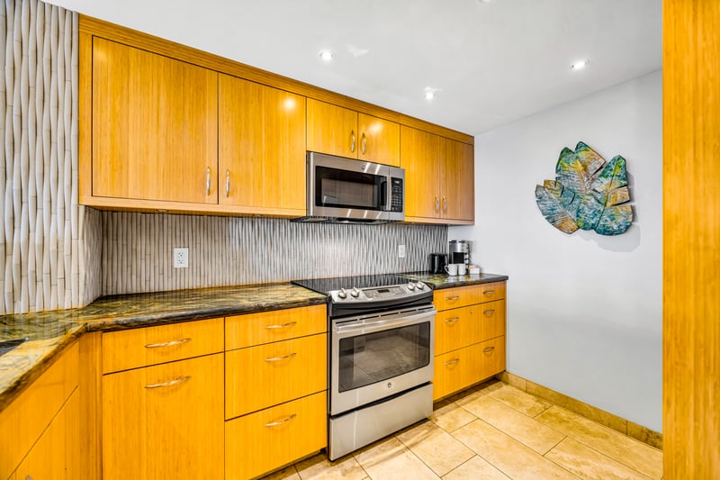 Practical and tidy layout equipped with all necessities, including a stove, full-size refridgerator and dishwasher.