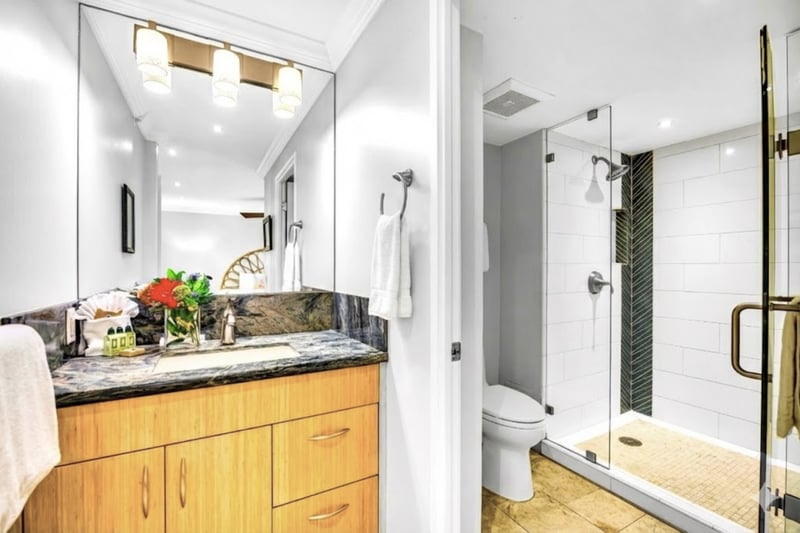 Sleek and modern, this features a granite vanity, glass walk-in shower, and premium amenities for a refreshing retreat.