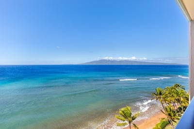 Float above the shoreline where emerald tides meet golden sand—your daily view is a watercolor of the sea
