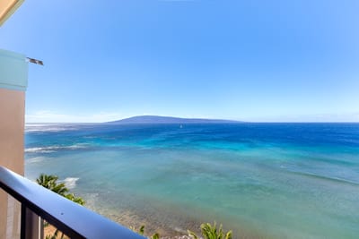 A view so vast it feels like it breathes—blues upon blues, kissed by sunlight, and framed in perfect serenity