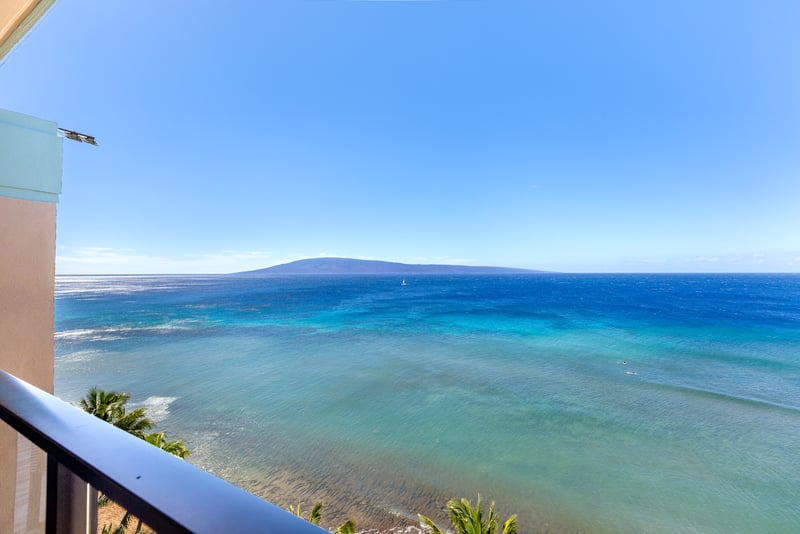 A view so vast it feels like it breathes—blues upon blues, kissed by sunlight, and framed in perfect serenity