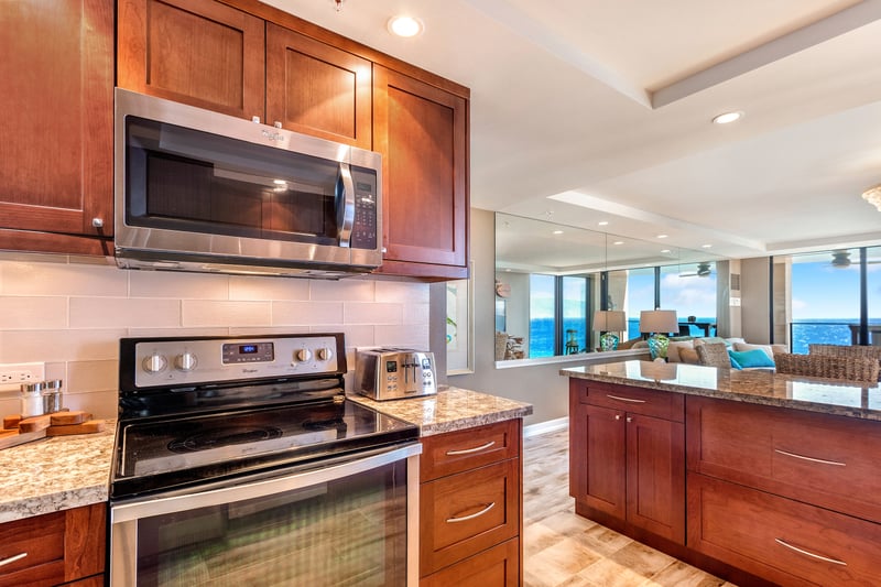 The gleam of stainless steel nestles within warm timber cabinetry, like moonlight tucked gently beneath a forest canopy