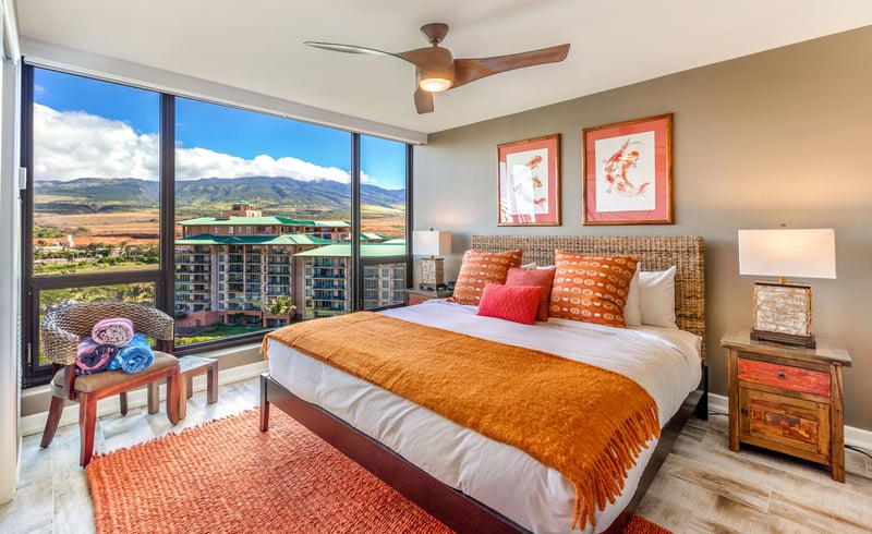 Wake up wrapped in coral-hued linens as golden light spills across the floor—this room glows like a Maui sunrise