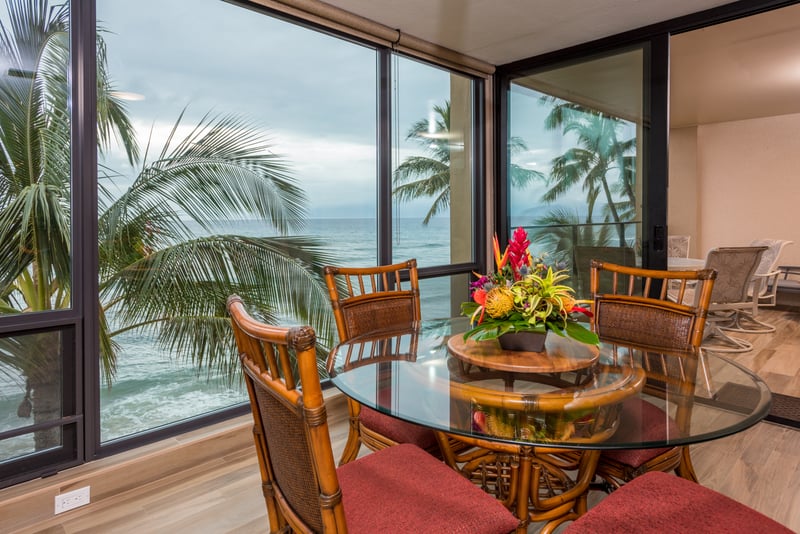 Gather around this bamboo table framed by palms and sea—a setting where breakfast feels like a celebration