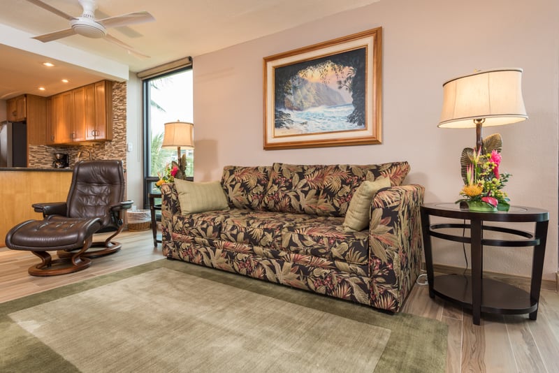 Sink into buttery leather recliners where comfort meets panoramic windows framing the lush Hawaiian coast