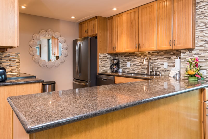 Tucked beneath a scalloped mirror’s smile, this golden-hued kitchen whispers stories of quiet mornings and cheerful toasts