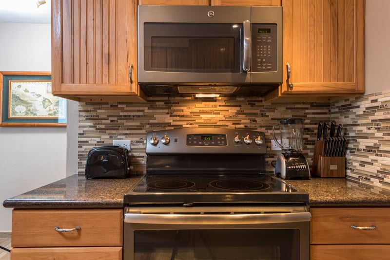 Black stainless accents bring a grounding grace to the space, where rustic meets refined in a seamless visual embrace