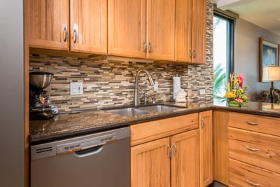 With countertops that catch every shimmer and backsplash stones laid like whispered secrets, the space sings with soul MAH-419