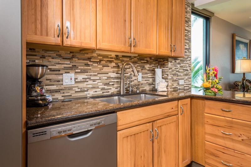 With countertops that catch every shimmer and backsplash stones laid like whispered secrets, the space sings with soul
