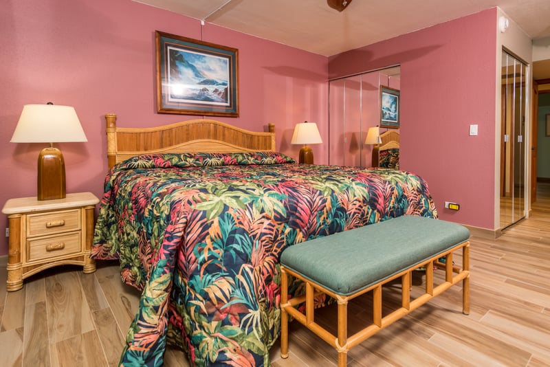 Wrapped in rosy walls and decked in tropical florals, this room feels like a sunset kissed it goodnight and never left