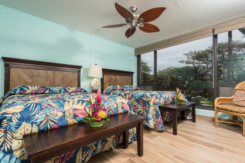 Twin tropical dreams await in these island-inspired beds—crowned with floral quilts and kissed by golden morning ligh