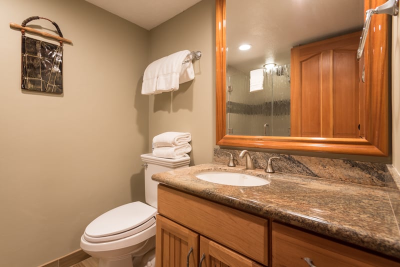 A cozy hideaway of polished stone and rustic grace, where even a quick freshen-up feels like a moment of peace