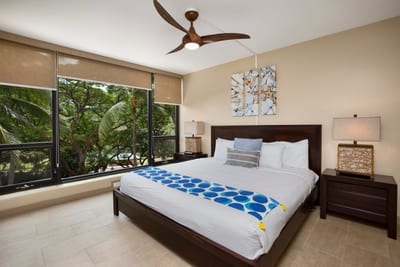 This cozy corner of paradise features a cloud-soft bed, custom wood details, and a front-row seat to nature’s lush theater