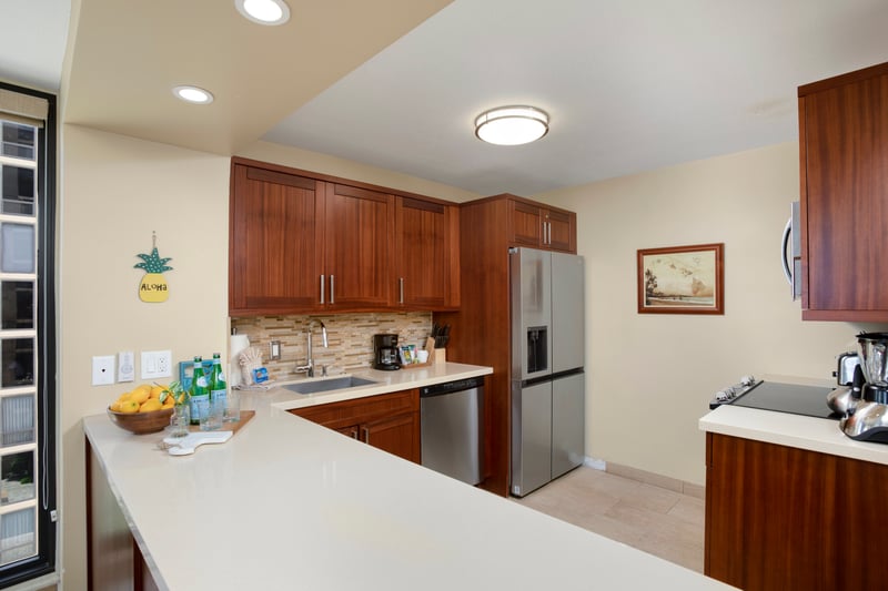 In the heart of the home, woodgrain cabinetry anchors the modern allure of appliances, art, and sun-dappled serenity MAH-611