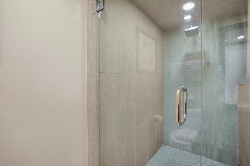 Unwind in luxury with a spacious, glass-enclosed rainfall shower—perfect for rejuvenating after a long day of adventure MAH-611