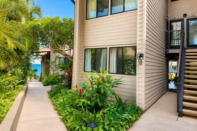 Follow the lush, palm-lined walkway to Building C's ground-floor entrance at Mahina Surf, where tropical plants frame your private front door -- just steps from the sound of the surf.