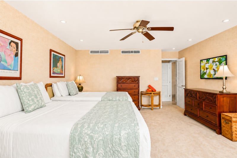 Bedroom dresser and TV at Maui Eldorado H207 — carved wood furnishings and French-door closet