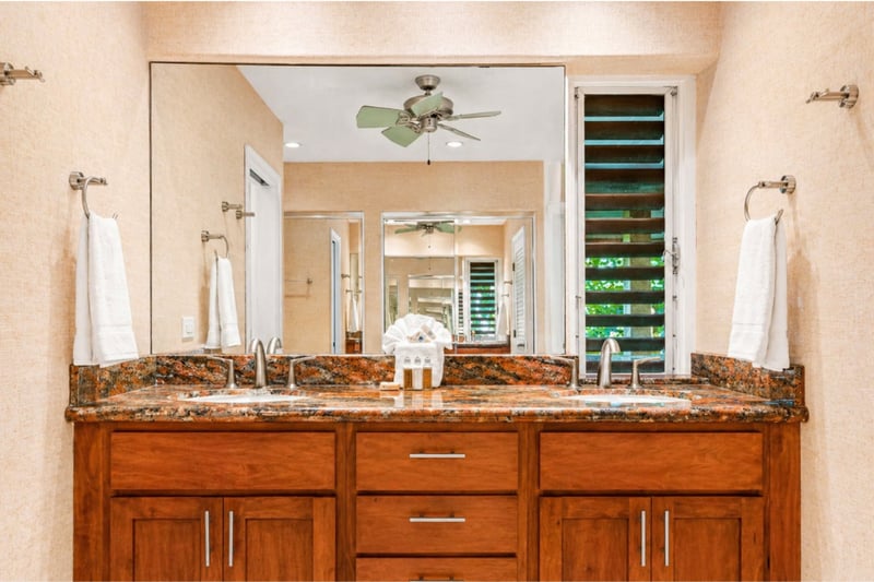 Walk-in shower at Maui Eldorado H207 — frameless glass enclosure with tiled accent wall and grab bar