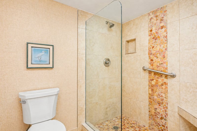 Primary bathroom double vanity at Maui Eldorado H207 — granite counters, dual sinks, and louvered window with garden view