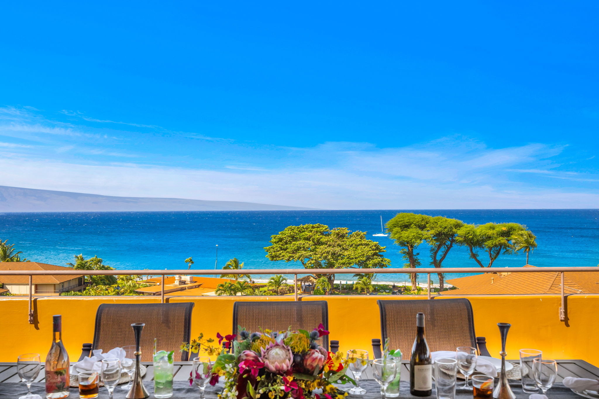 Step onto your spacious lanai to take in wide ocean views, golden sand, and the sound of the waves.