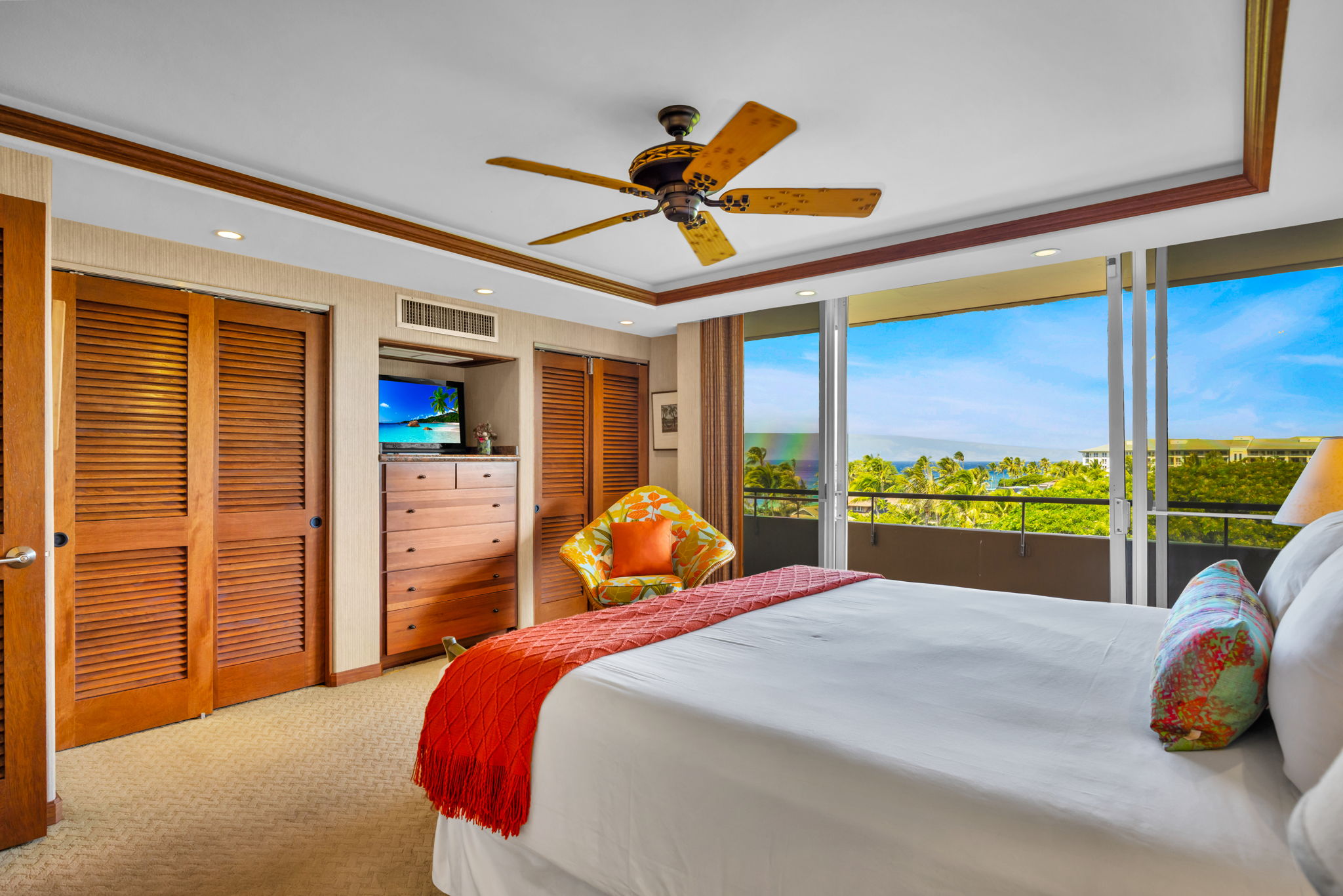 Cozy reading corner and ceiling fan complete this restful primary retreat.